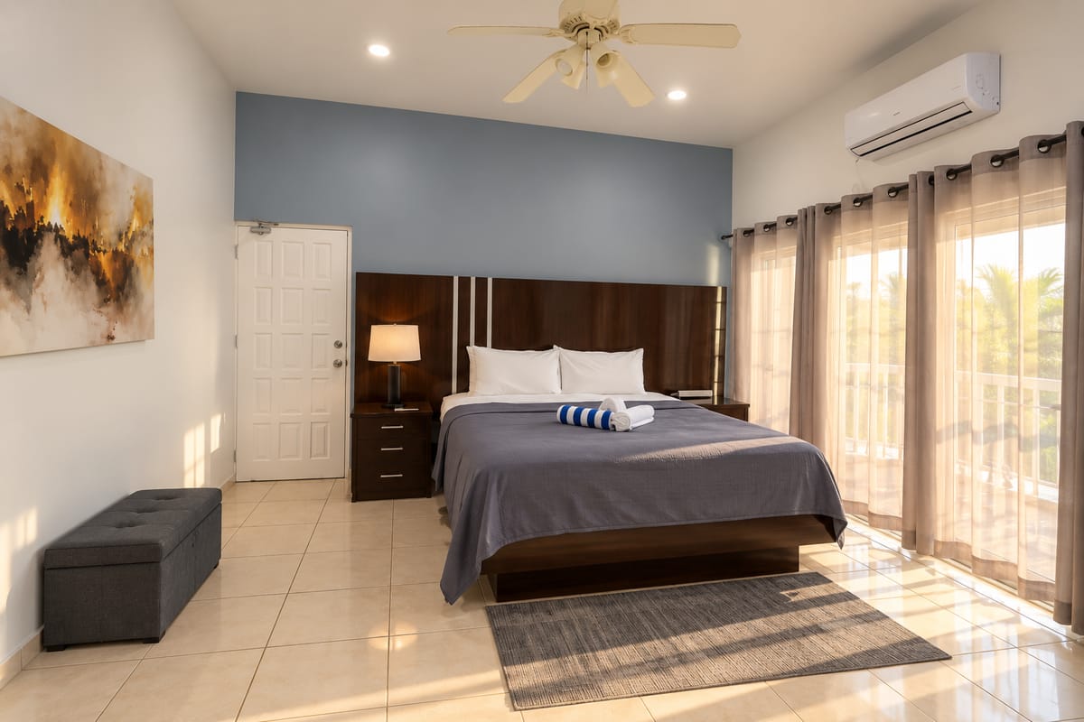 Cap Estate villa king bedroom with artwork and balcony, Paris Villas